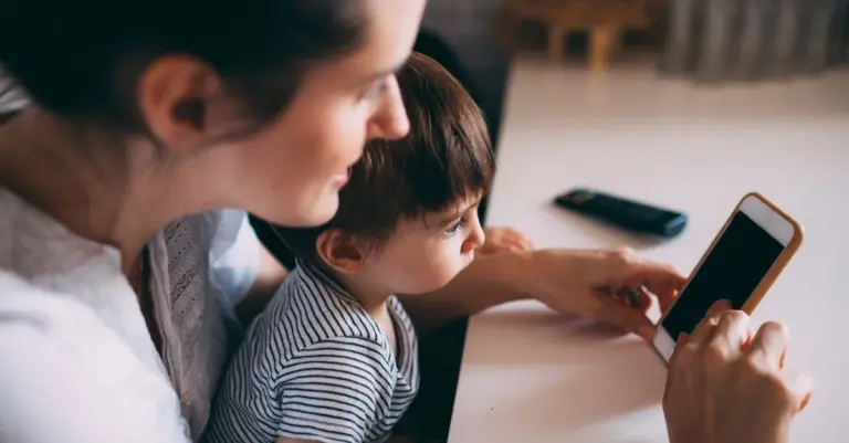 Mãe e filho usando o celular em casa