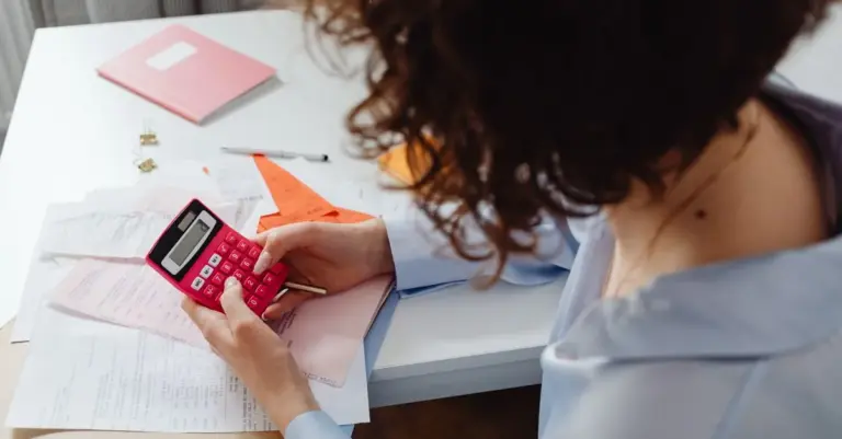Mulher calculando contas para organizar dívidas
